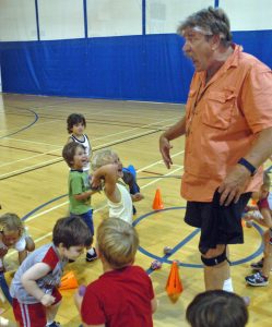 Young kids laughing at their teacher's goofy antics.